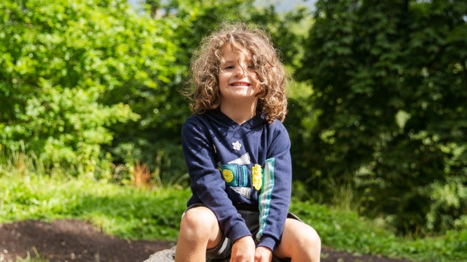 A grinning child playing at the Crow Wood play area at Lyme Park, Cheshire
